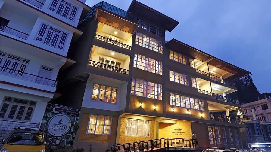 A low-high angle of a well-lit facade of Summit Newa Regency & Spa, Pelling