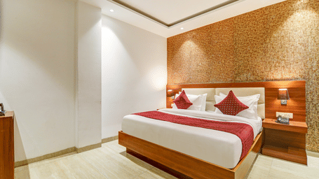 High-angle corner view of a bright hotel room highlighting the minimalist decor and wooden finishes - Hotel Velocity