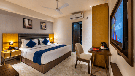 Elegant reception area with decorative wall art and welcoming front desk at Lords Studio Inn, Jamnagar.