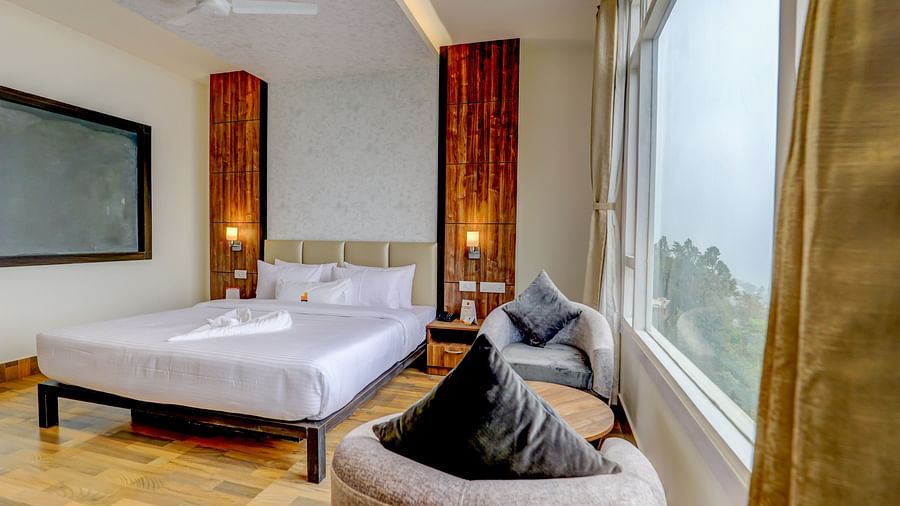 view of king size bed and TV of a Deluxe Room Banari Regency by Summit, Namchi