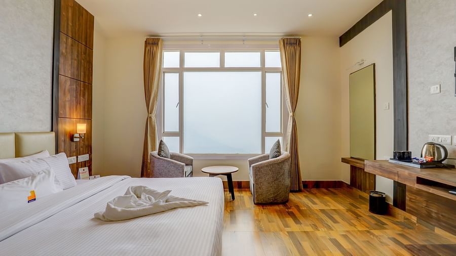 view of king size bed and TV of a Deluxe Room Banari Regency by Summit, Namchi