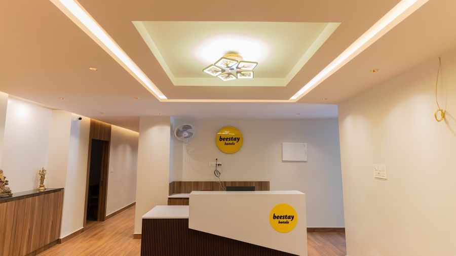Reception desk with warm lighting and welcoming decor at Beestay Hotels, Rajahmundry.