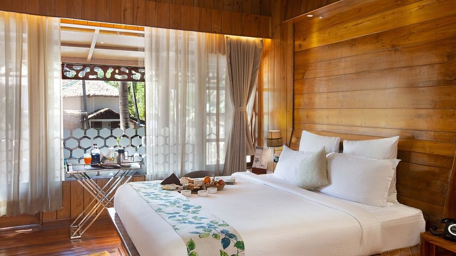 Coral Turquoise at Coral Reef Resort and Spa in Havelock featuring a plush bed placed next to the large window which extended to the doorway to the balcony