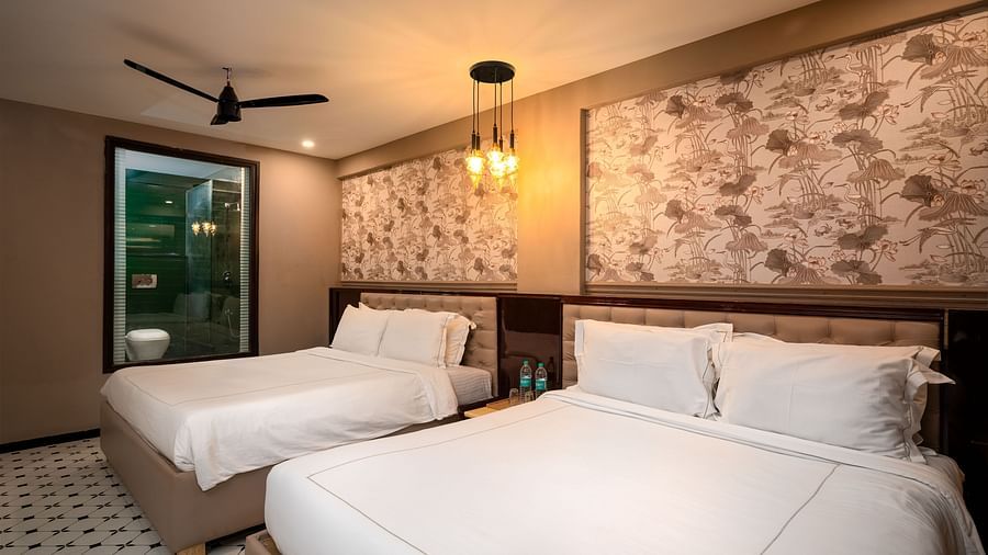 A beautifully designed room with a comfortable bed, soft lighting, and contemporary furnishings at Crescent Resort, Goa
