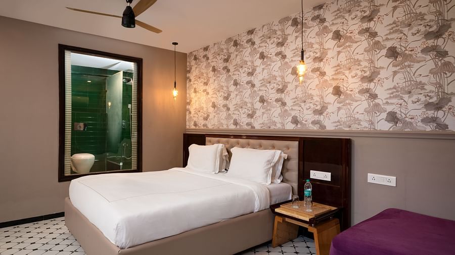 A portrait image showing a well-furnished room with contemporary décor and comfortable furnishings at Crescent Resort, Goa