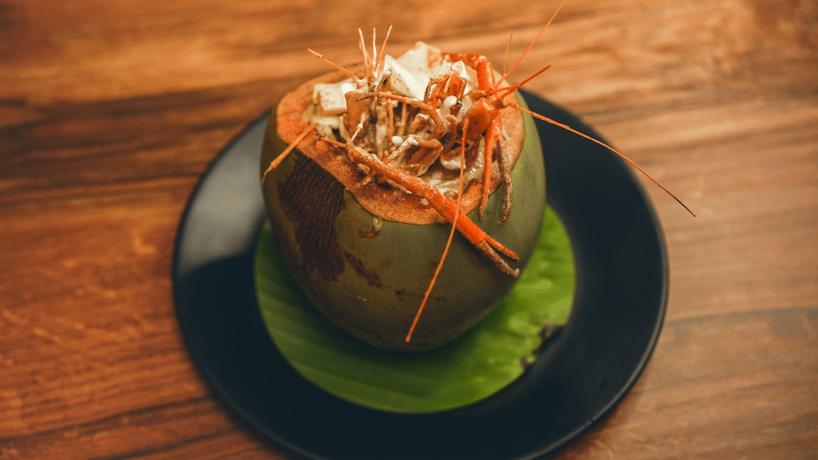image of whole prawns made in bengali style served in a coconut shell - Dip Holidays, Birbhum