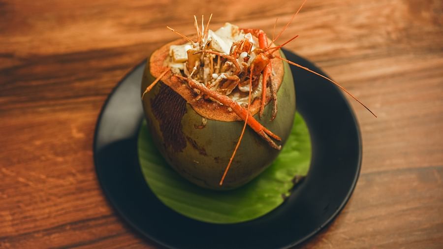 image of whole prawns made in bengali style served in a coconut shell - Dip Holidays, Birbhum
