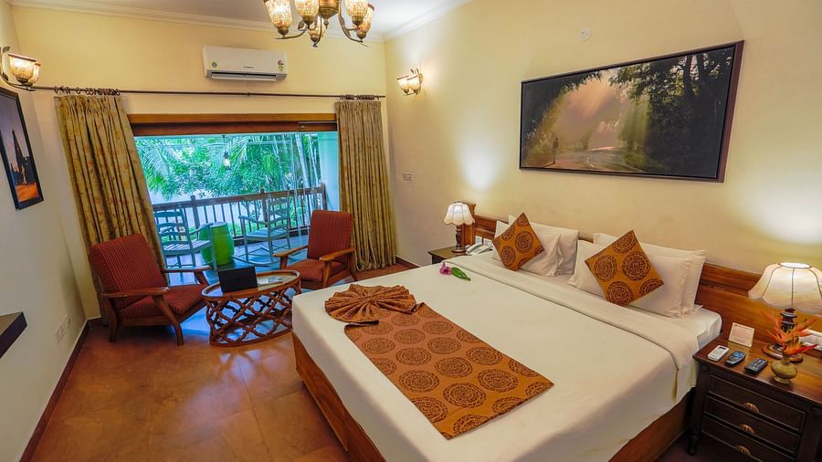  Spacious bed with decorative blankets, flanked by two bedside tables with lamps, and a large window to the side