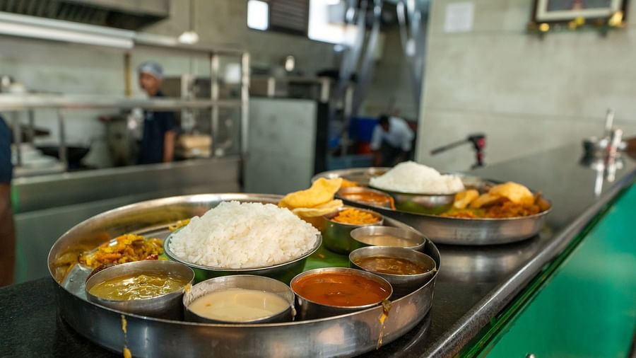 Two plates placed on the counter at Hari Govinda's, filled with small bowls of South Indian dishes