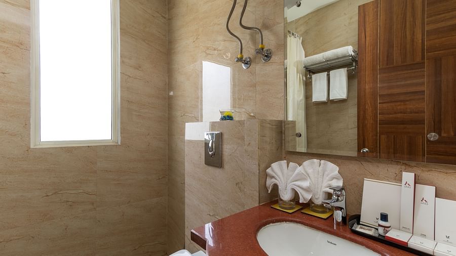 A modern and spacious bathroom with a shower, and plenty of natural light | Inde Hotel Cyber City 