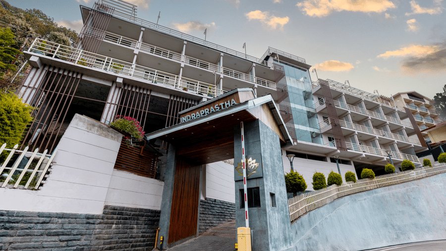 An exterior view of Indraprastha Resort & Spa, McLeod Ganj with multi-level building, entrance area, steps, and railings leading up.