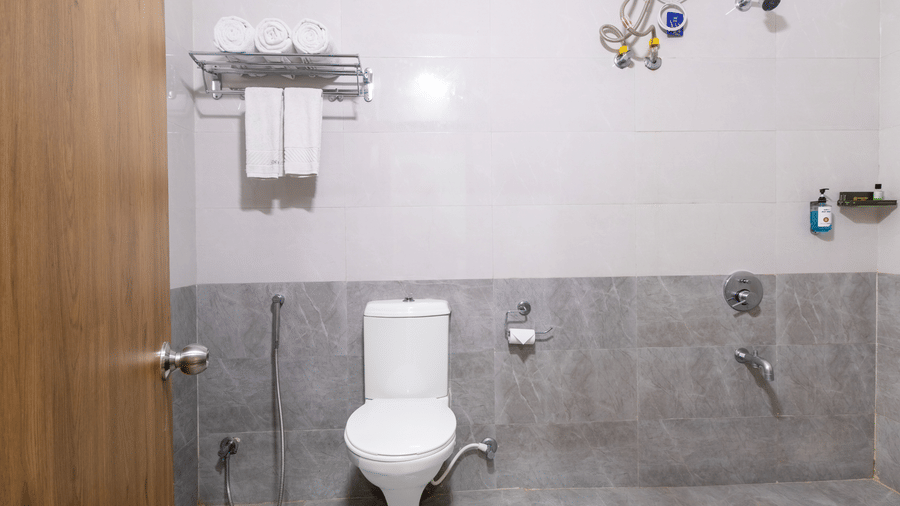 Washroom with wall-mounted towel rack at Lemonridge by Monday Hotels - Kukatpally.