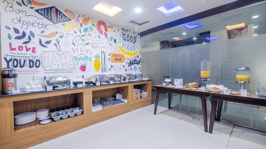 Restaurant featuring buffet options and artistic wall decor at Lemonridge by Monday Hotels - Kukatpally.