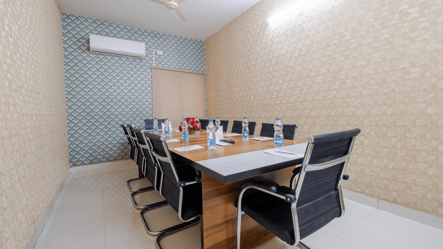 Boardroom setup with table and seating at Lemonridge by Monday Hotels - Kukatpally.