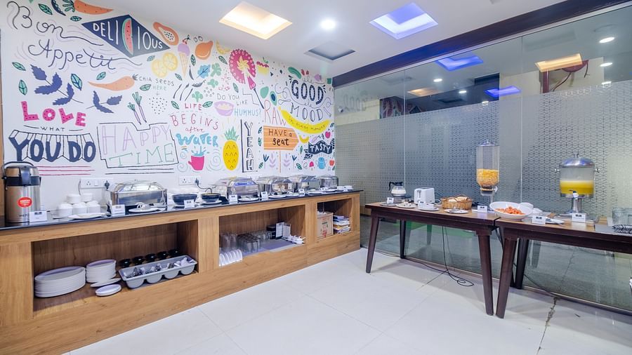 Dining area featuring buffet options and artistic wall decor at Lemonridge Hotels