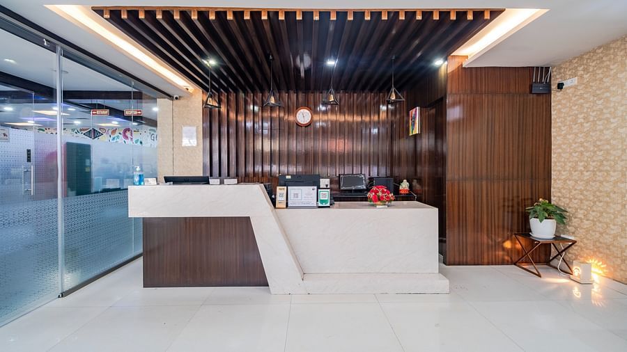 Reception front view with a wood-decorated ceiling and lights at Lemonridge Hotels