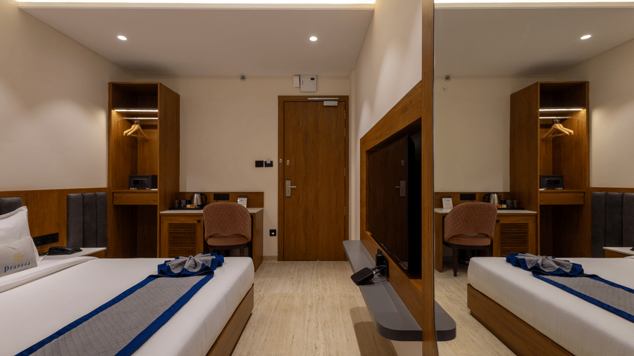 Neatly designed guest room with wardrobe and study desk at Pravasa Stay Bapat Square, Indore.