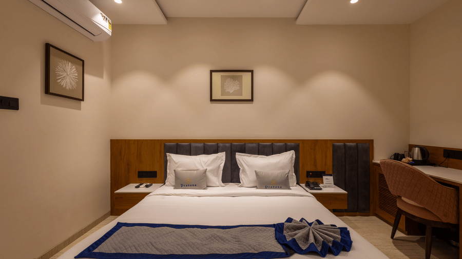A view of the bedroom with plush bedding at Pravasa Stay Bapat Square, Indore.