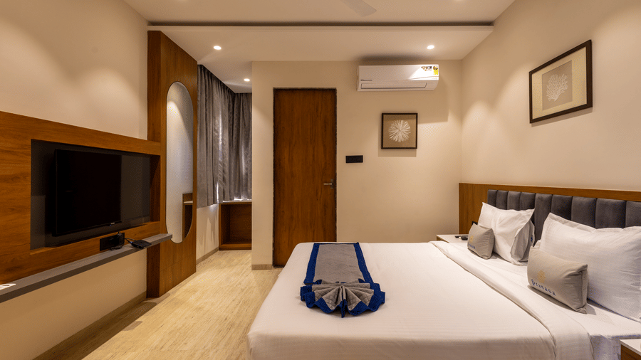 Premium room interior with warm lighting and elegant furnishings at Pravasa Stay Bapat Square, Indore.