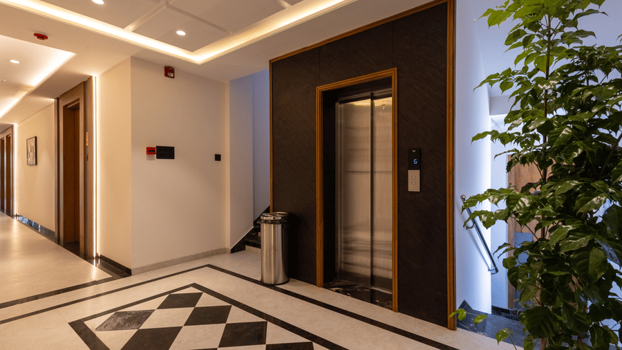 A vertical view of the lift lobby, showcasing the modern design at Pravasa Stay Bapat Square, Indore.