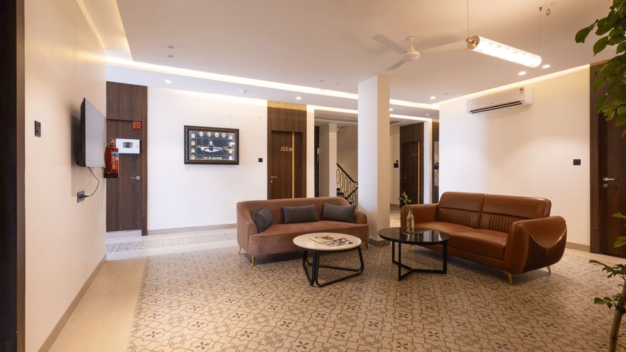 Interior view of the common area/lobby with seating at Pravasa Stay Luv Kush, Indore.