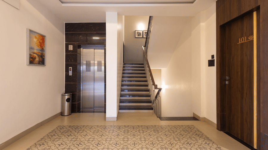 Interior view of the ground floor hallway and staircase at Pravasa Stay Luv Kush, Indore.