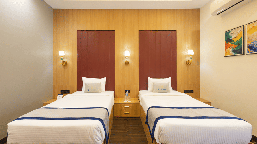 Interior view of a guest room showing 2 single beds with 2 headboard at Pravasa Stay Luv Kush, Indore.