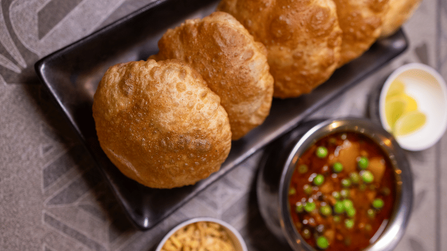 View of Indian fried bread, likely bhatura, with a chole (chickpea) curry side dish at Pravasa Stay Luv Kush, Indore.