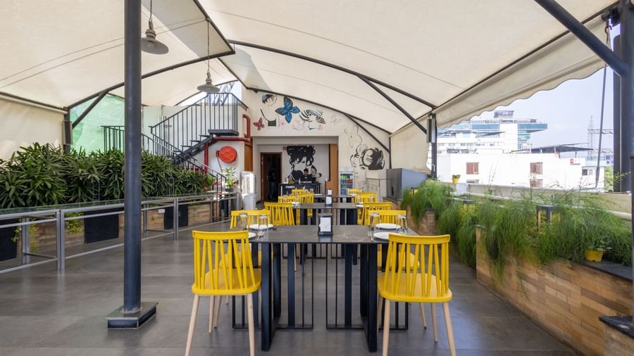 Rooftop dining setup in the Pravasa Cafe at Pravasa Stay Vijay Nagar, Indore.