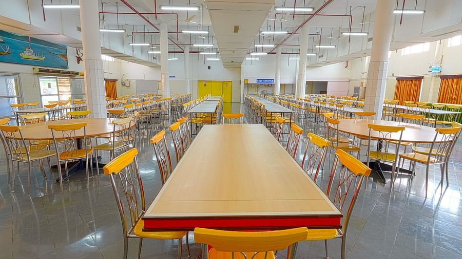 A dining hall with a long table paired with six chairs at Sahara - Group Dining in Hyderabad.