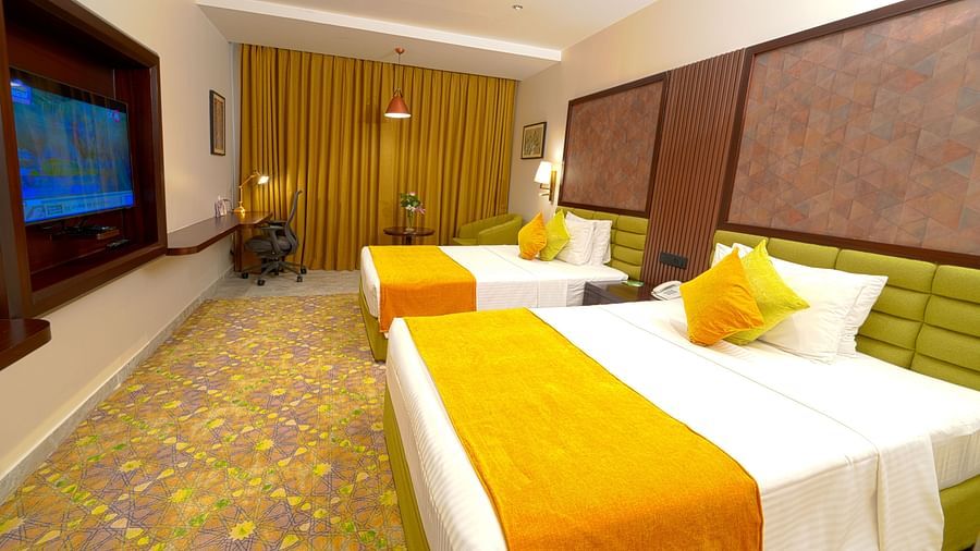 Room at Sitara Luxury Hotel in Hyderabad near Ramoji Film City with twin  beds and a television