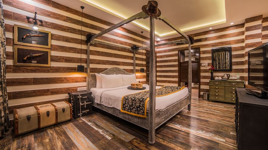  A stylish hotel room featuring a four-poster bed and striped walls in a warm, neutral palette A grand hotel suite with an opulent red and white decor, large bed, and seating area, reflecting a traditional style at Sitara Luxury Hotel in Hyderabad near Ram