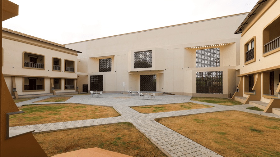 A view of the resort's clean, modern architectural lines and paved garden paths - Tathastu Chavri Resort, Jawai
