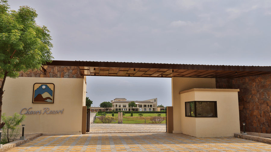 The main entrance gate of the resort featuring the official logo and stone architecture - Tathastu Chavri Resort, Jawai