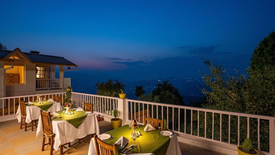 Restaurant sit out area with tables and chairs at Te Aroha By Shervani, Mukteshwar