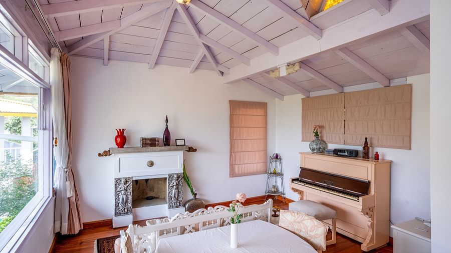 A living room with a piano and a sofa at Te Aroha By Shervani, Mukteshwar