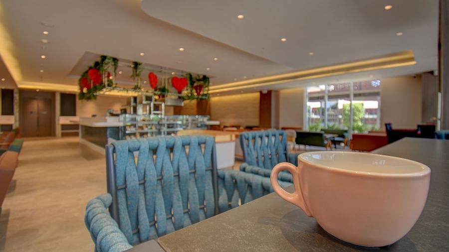 Close up of two sister's cafe The SSK Solitaire Boutique Hotel & Spa, Gangapur Road - Nashik featuring chair, tables and a cup