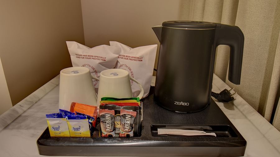 Room amenities featuring tea and coffee maker and other things kept on a table at The SSK Solitaire Boutique Hotel & Spa, Gangapur Road - Nashik