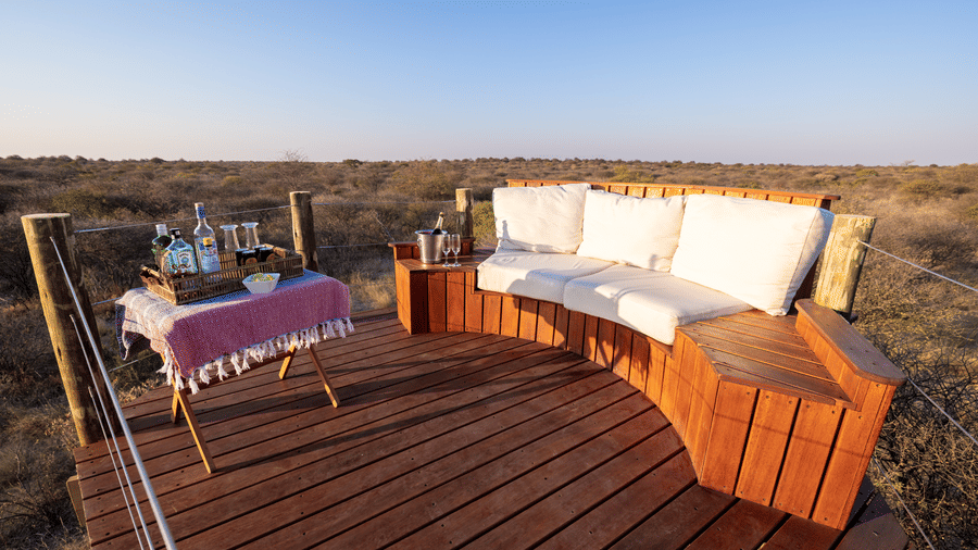 Outdoor bush breakfast set up on a wooden deck in the Kalahari at Evolve Back resort