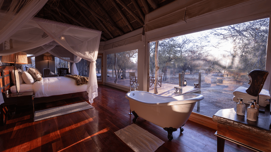 Luxury tent bedroom with panoramic bush views at Evolve Back Kalahari