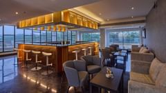 tables, chairs, and stools in the bar at Grand Continent, Mahabalipuram