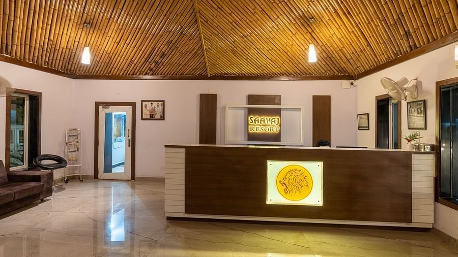  The reception area with a wooden desk, a newspaper stand, and framed photos and achievements on the wall.