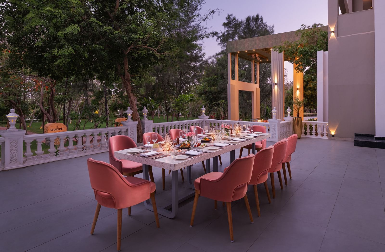 An elegant dining setting placed outdoors at Essentia Luxury Resort & Spa, Udaipur. 