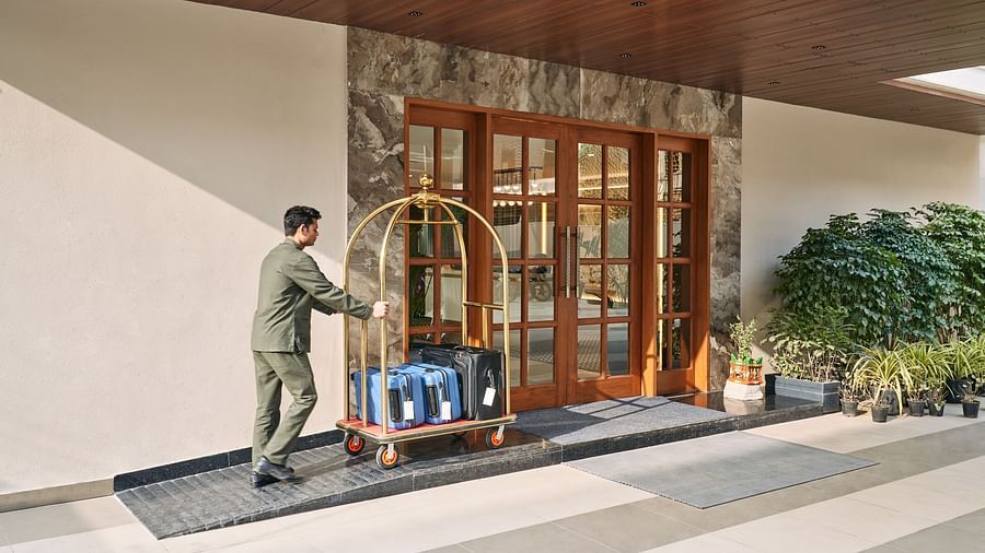 a porter pushing a luggage cart at Triptam Hotel, Vrindavan