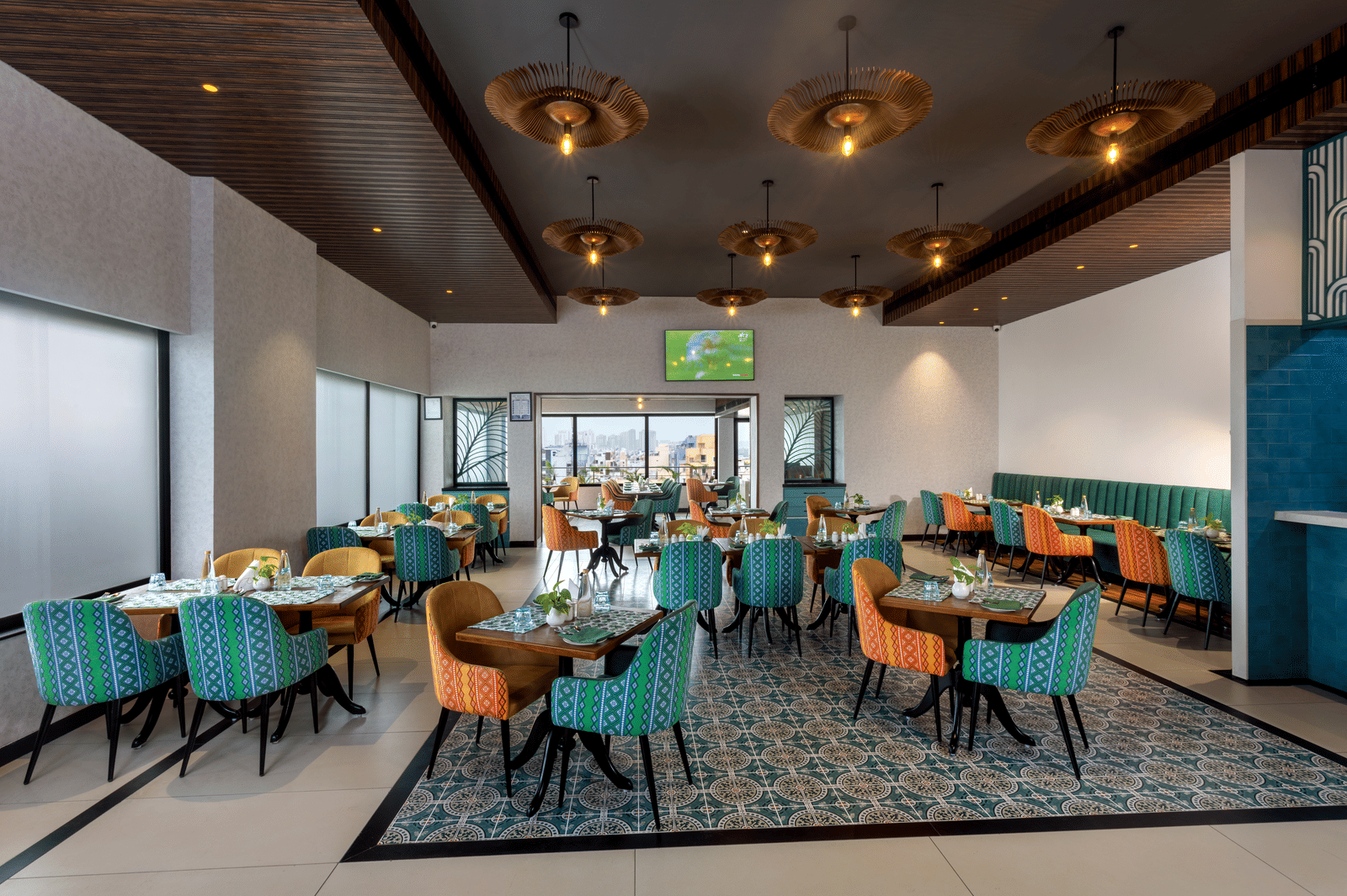 Spacious restaurant at Shalimar in Zibe Luxe Hyderabad by GRT Hotels offering a bright, city-facing setting with stylish ceiling lights - Best Food in Hyderabad