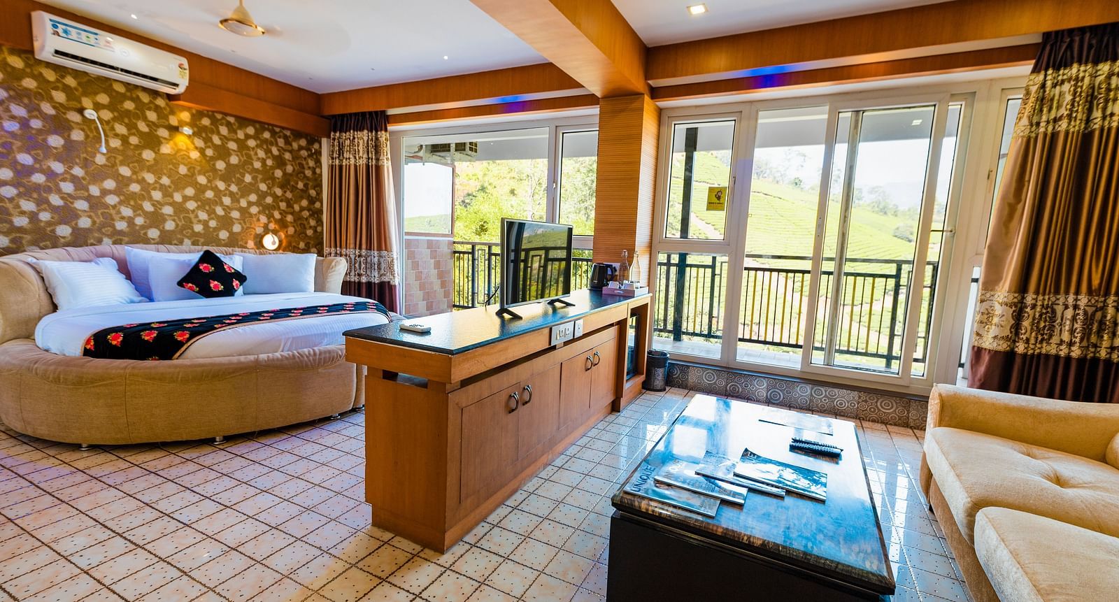 A round bed and a table at Honeymoon Suite at Parakkat Nature Hotel and Resorts Munnar