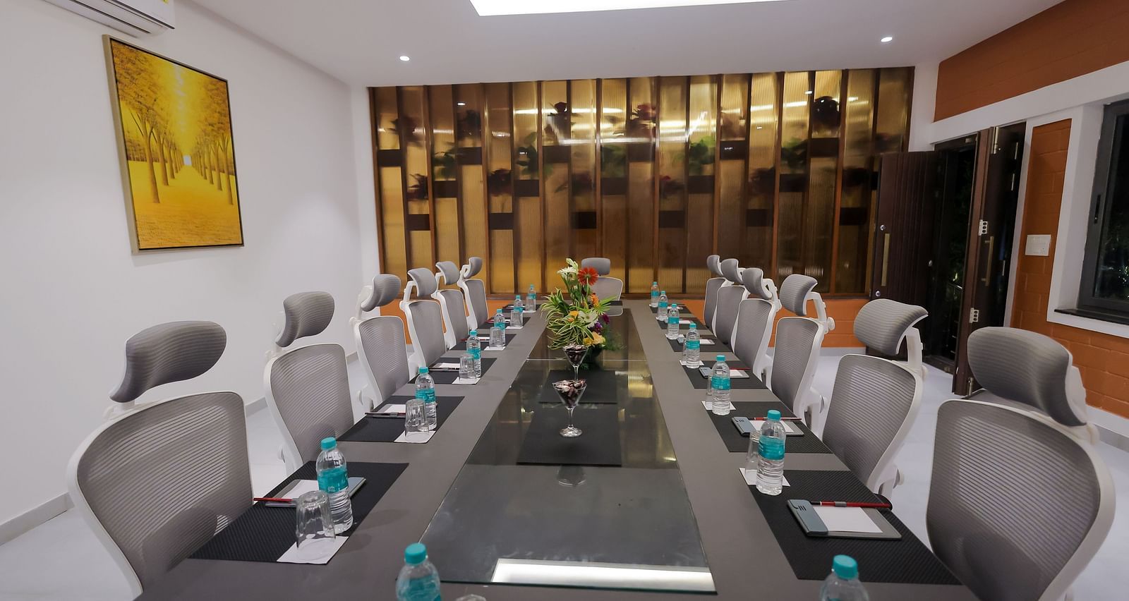 Modern boardroom at Trishvam Symphony, Krishnagiri, set with executive chairs, water bottles, and a professional meeting setup.