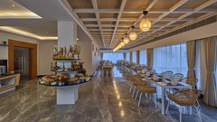 chairs and tables beside a buffet counter in one of the dining outlets at Grand Continent, Mahabalipuram