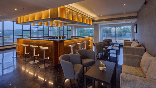tables, chairs, and stools in the bar at Grand Continent, Mahabalipuram