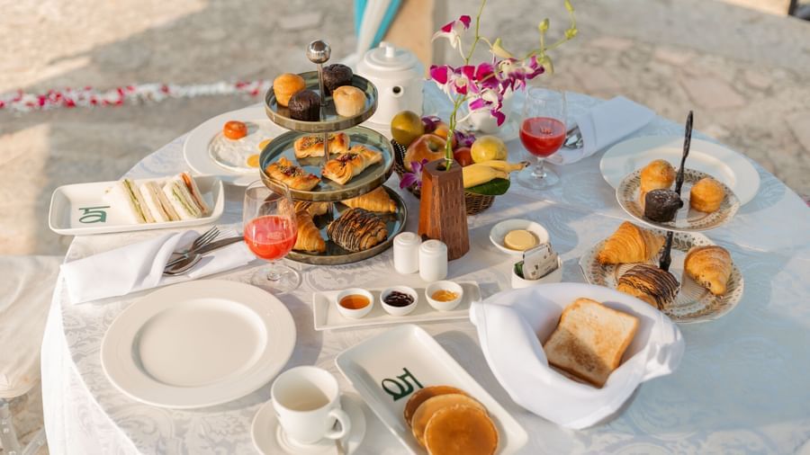 a small breakfast buffet on a round table at Ananta Spa and Resort, Ajabgarh